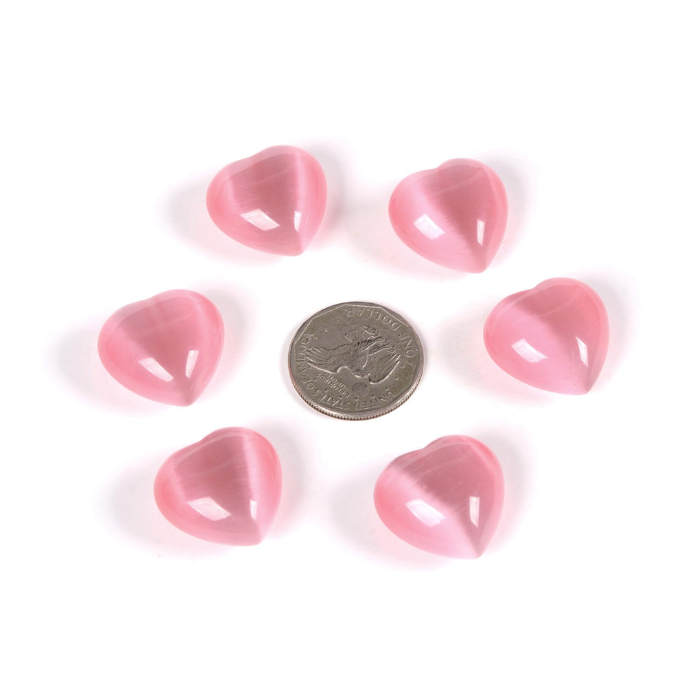Justinstones pink cats-eye heart stones held in hand for gift-ready wellness decor.