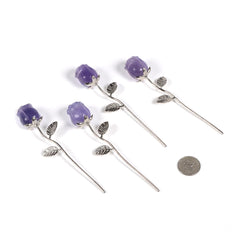 Justinstones Purple Fluorite Rose displayed on a desk enhances ambient room decor.