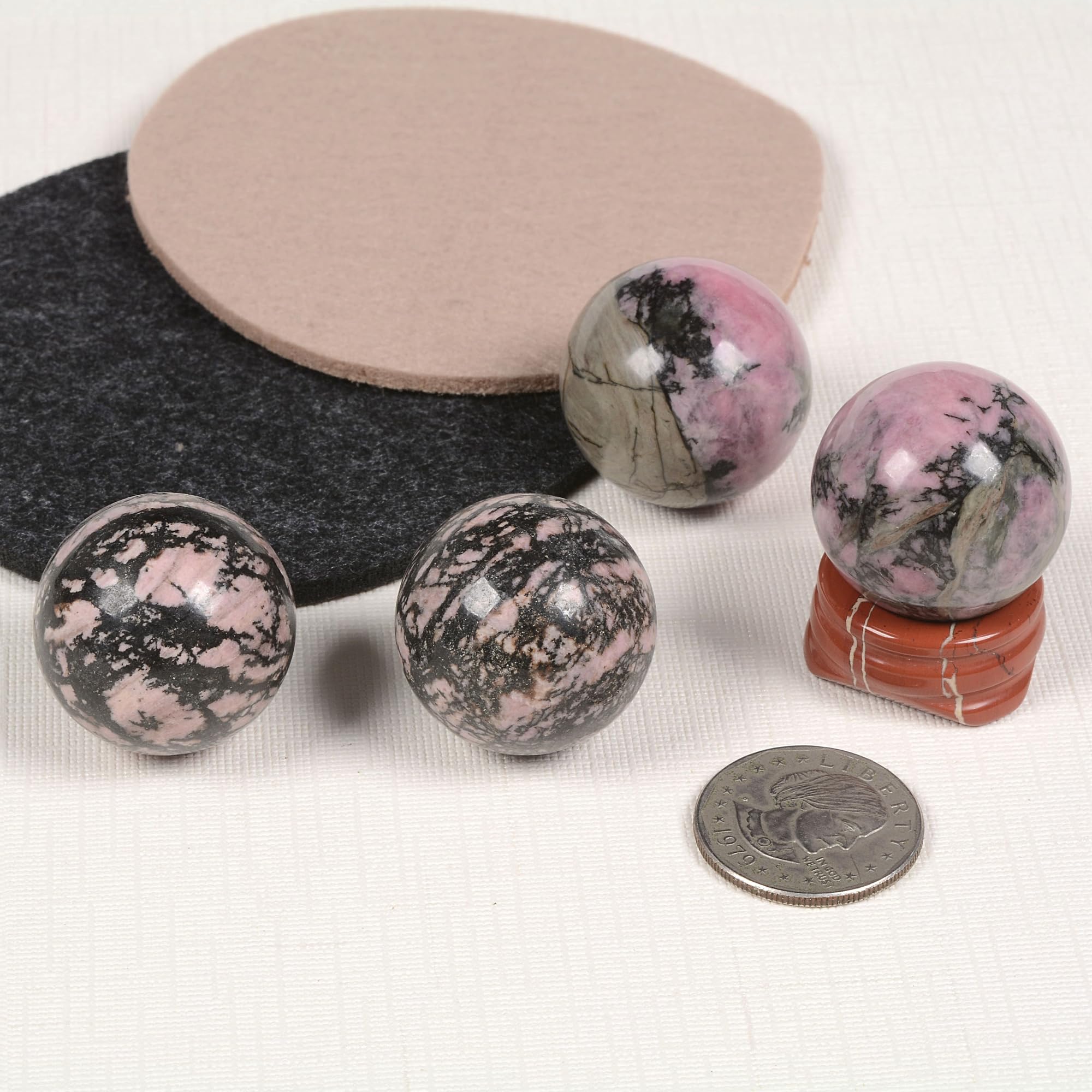 Justinstones red jasper stand supports rhodonite sphere for display and feng shui.