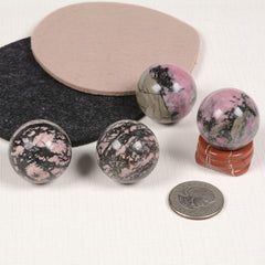 Justinstones red jasper stand supports rhodonite sphere for display and feng shui.