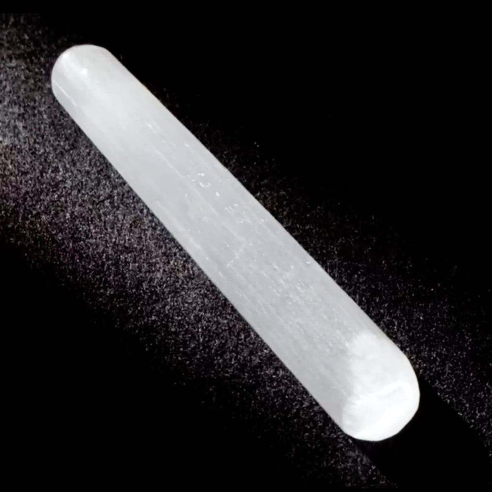 Close-up of Kalifano selenite wand surface with translucent glow.