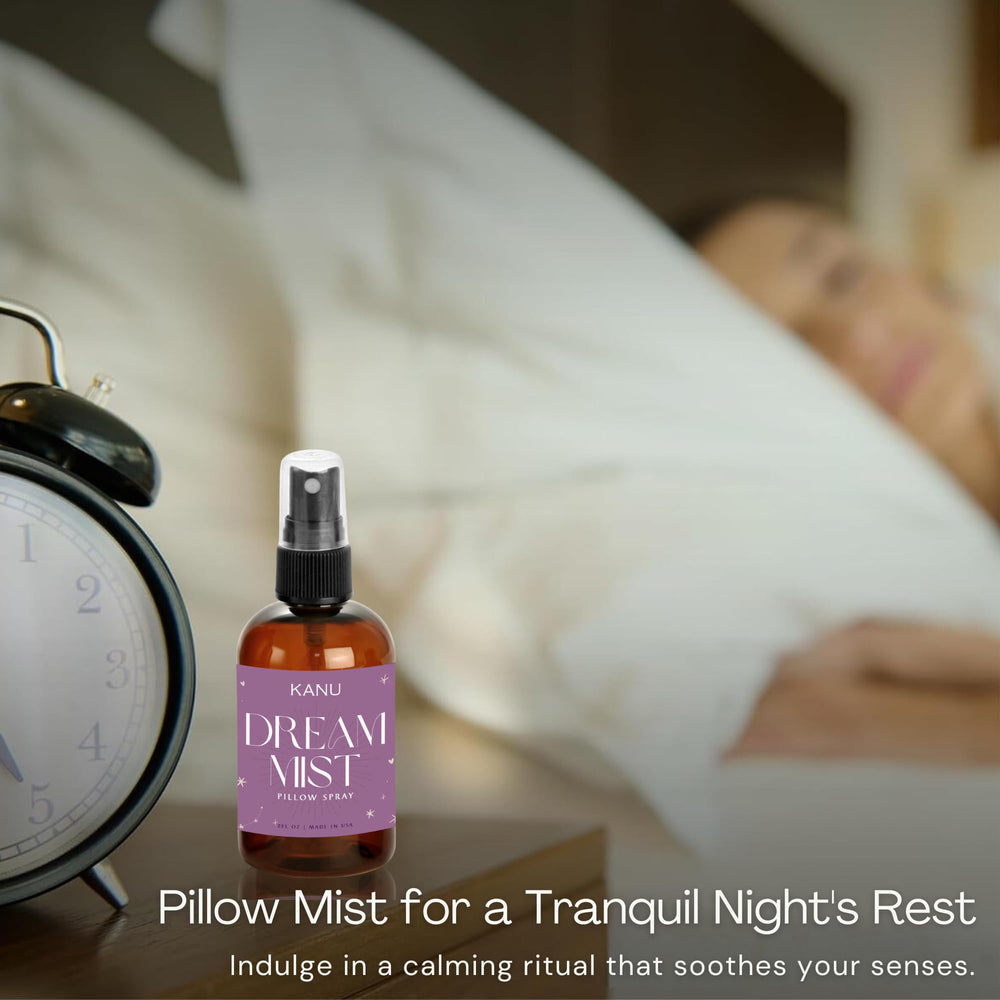 KANU Night Time Pillow Spray on a nightstand beside a book and glass of water