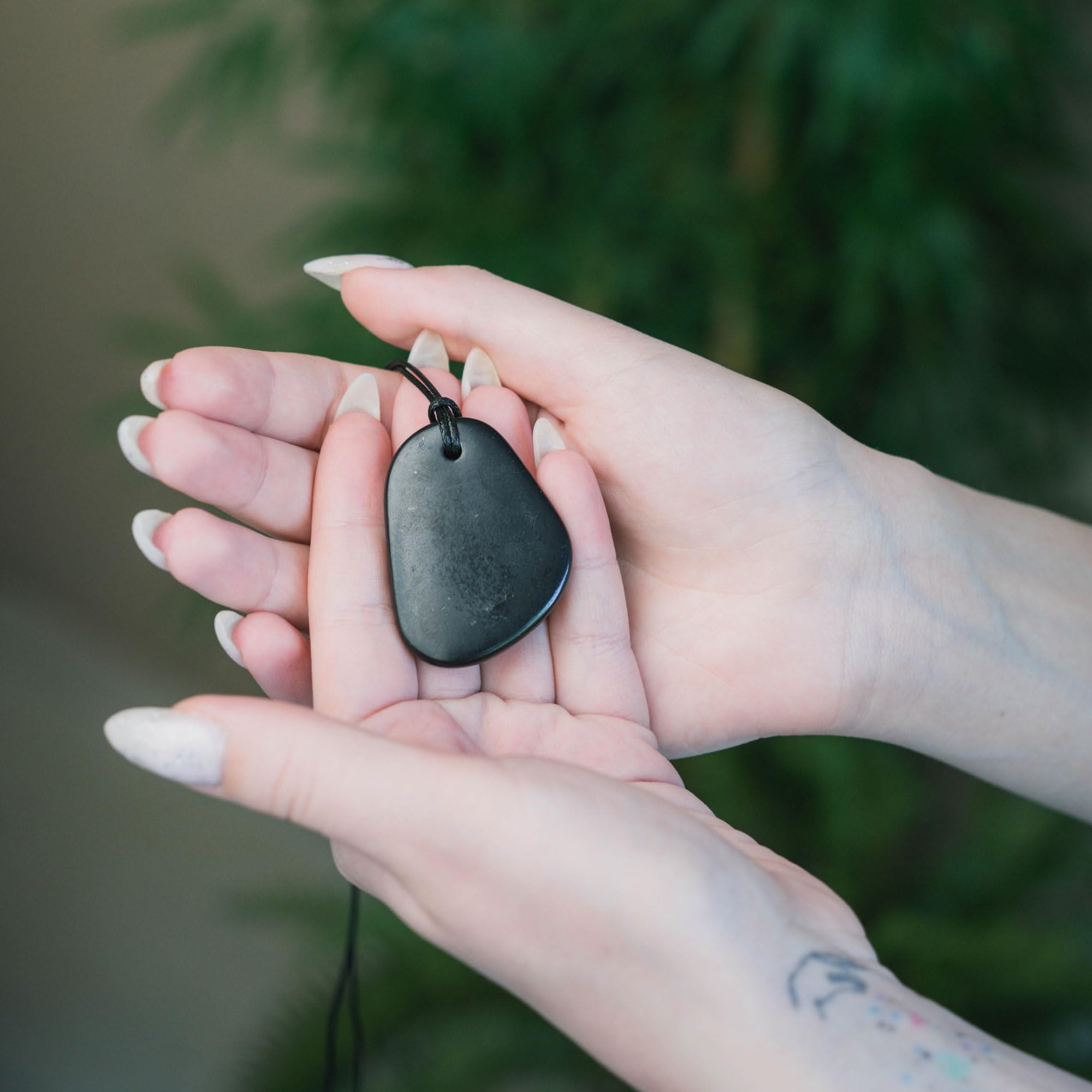 Karelian Heritage shungite pendant closeup highlights natural texture and balanced energy feel.