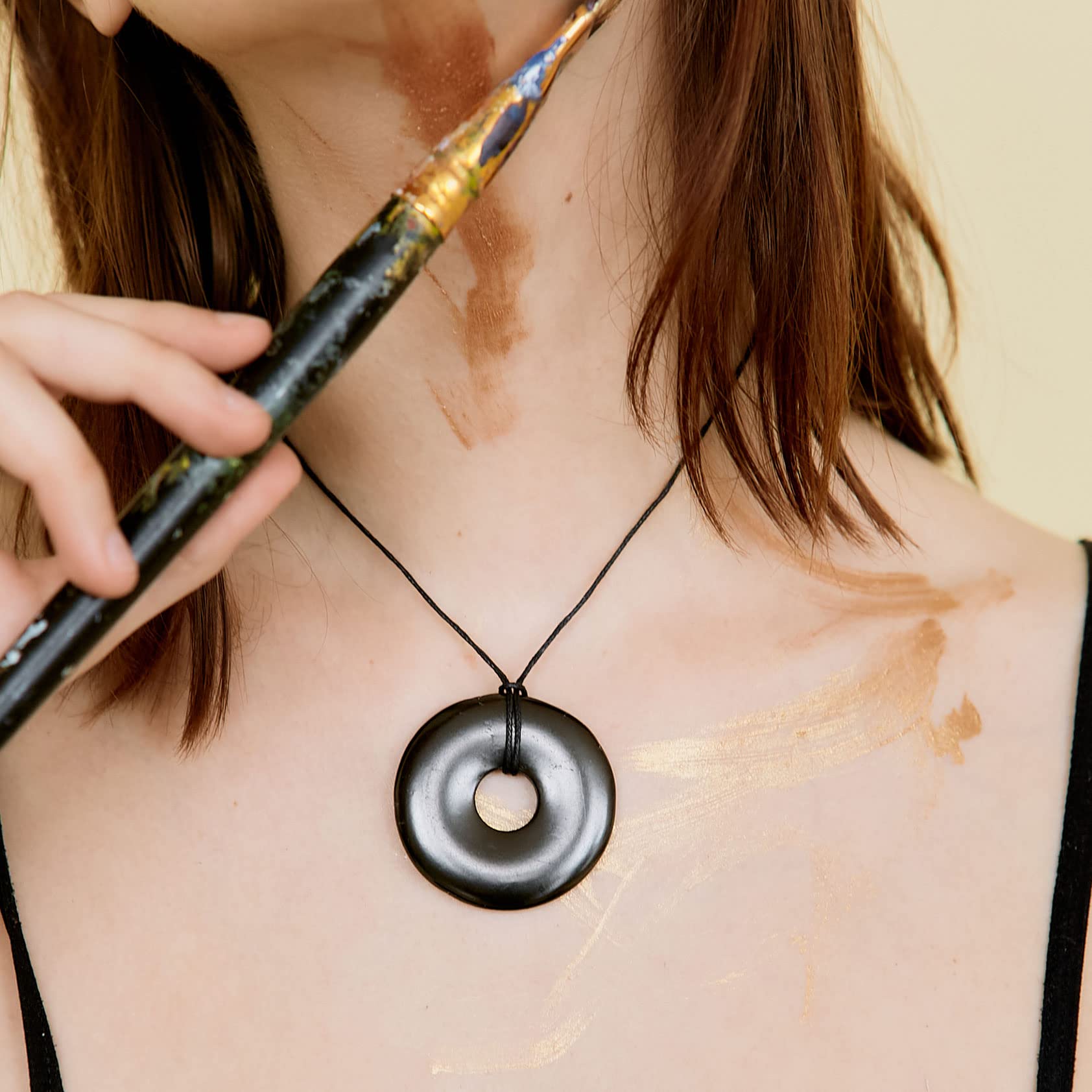 Karelian Heritage shungite necklace near root chakra for grounding