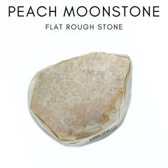 Karma Gems Peach Moonstone flat stone in hand for emotional balance.
