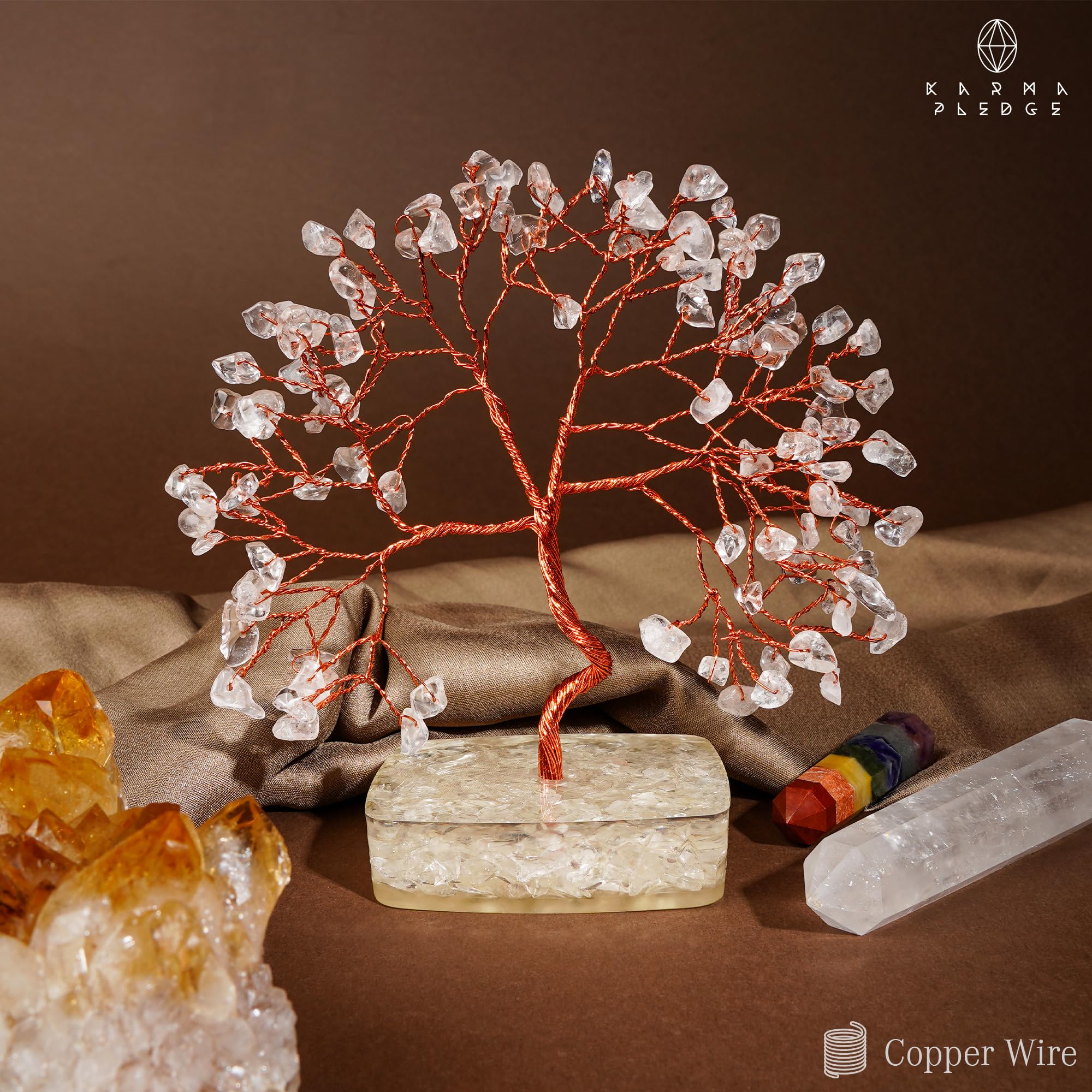 KARMAPLEDGE Clear Quartz Tree on office desk, focal point for focus.
