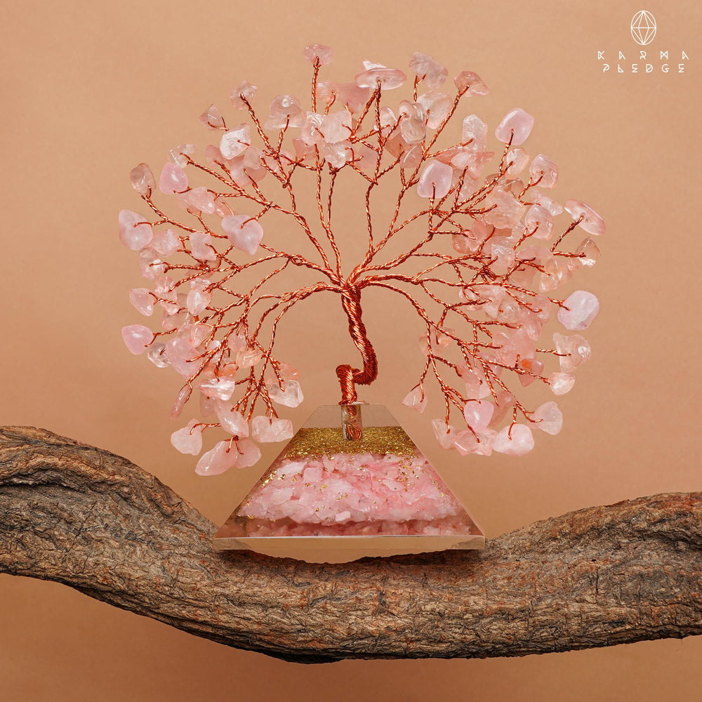KARMAPLEDGE Rose Quartz Crystal Tree stands beside plants for balanced vibes.