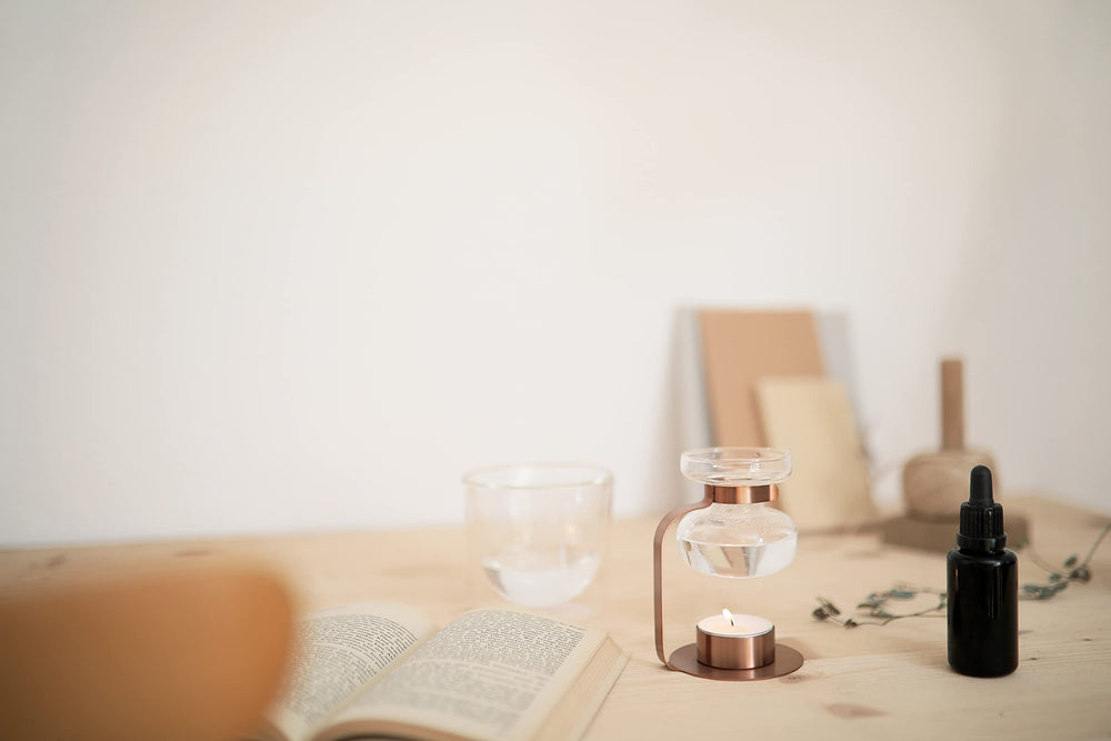 Kinto Aroma Oil Warmer on desk creates cozy ambience for evenings.