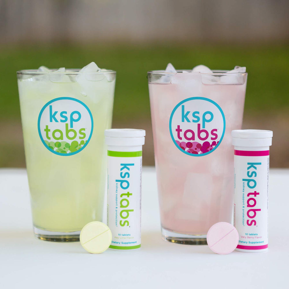 Glass of water with a Sunrise Citrus tablet ready to fizz.