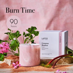 Candle displayed on a bedside table creating a cozy mood.