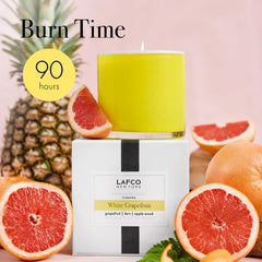 Unlit candle ready to elevate entryway with refreshing grapefruit scent.