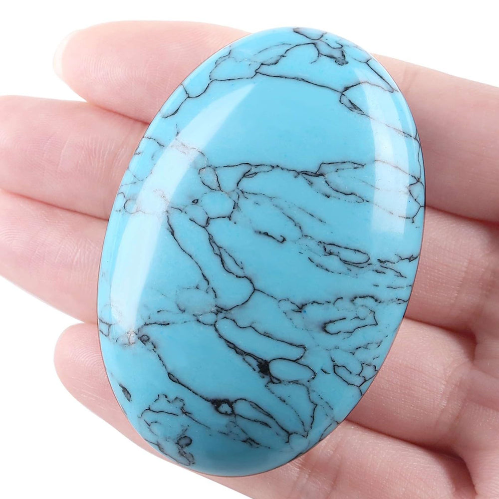 Laidanla turquoise palm stone in hand for portable daily meditation.
