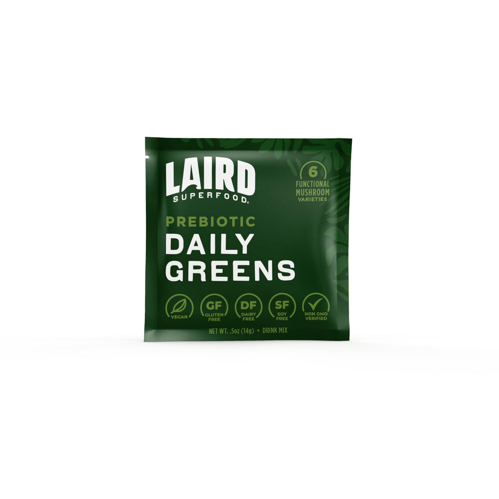 Prepared shake with Laird Superfood Prebiotic Daily Greens being stirred.