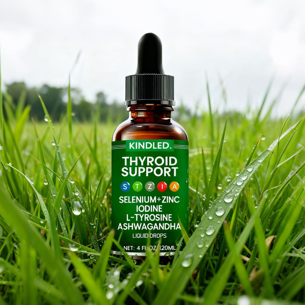 LANZF Kindled Thyroid Support Drops bottle beside water for easy mix-in.
