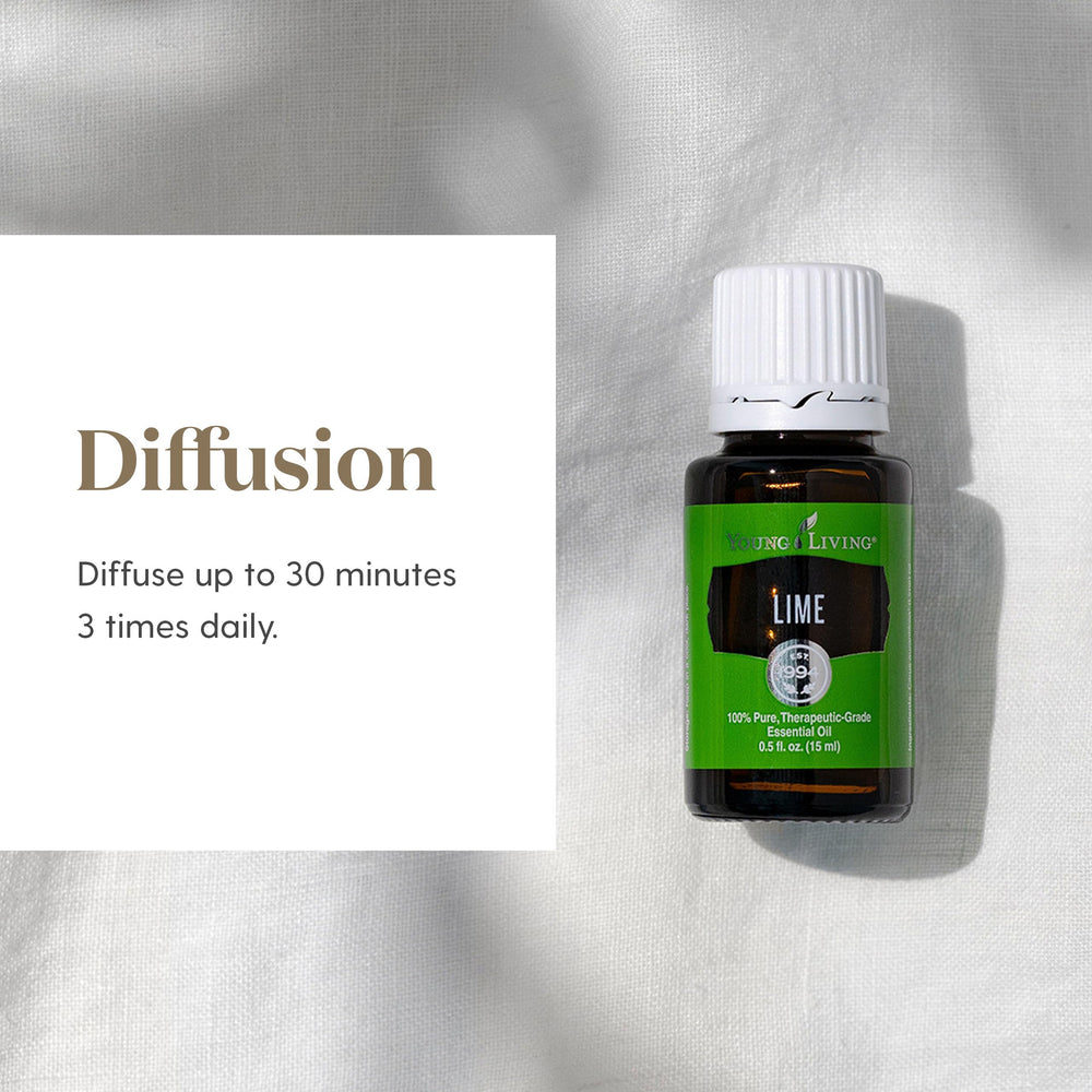 Glass bottle of Lime essential oil resting on a countertop.