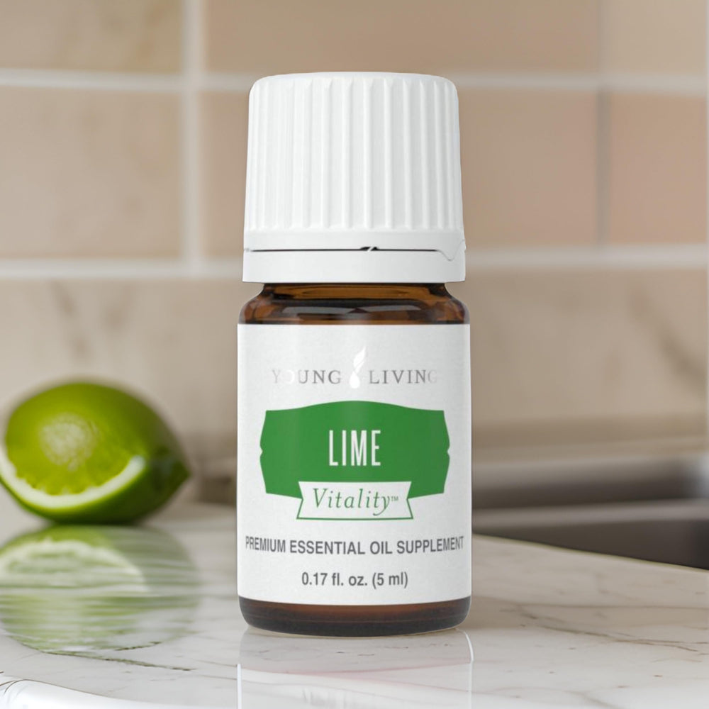 Young Living Lime Vitality drops over fresh greens for flavor.