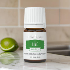 Young Living Lime Vitality drops over fresh greens for flavor.