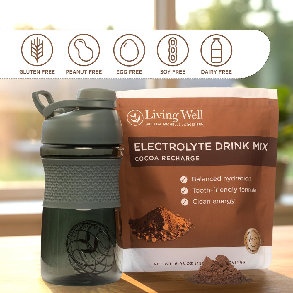 Living Well with Dr. Michelle stirring in glass indicates smooth chocolate hydration.