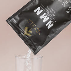 LongLiv NMN powder dissolving in water for quick mixing and flexible dosing.