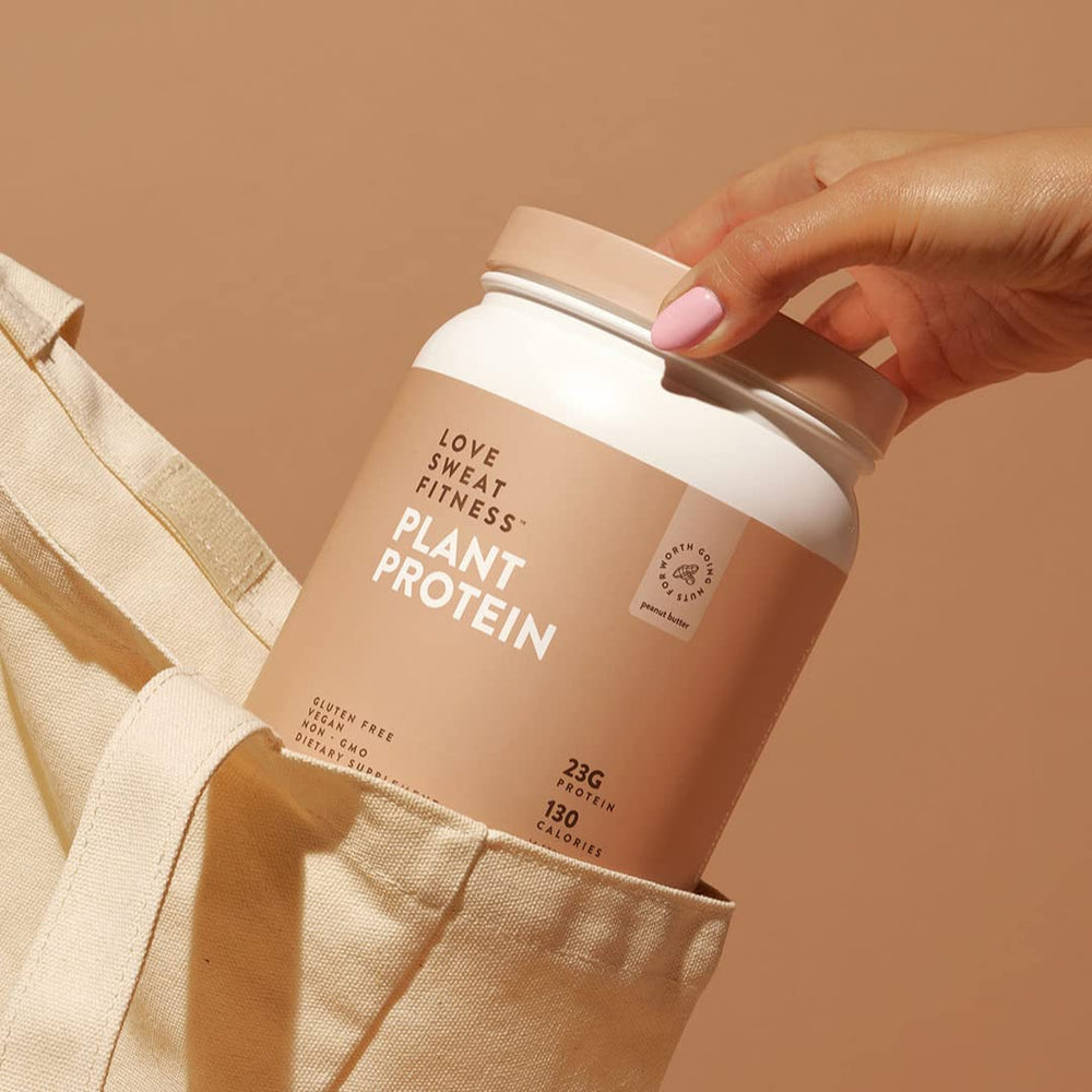 Love Sweat Fitness protein powder with shaker and spoon ready for meals.