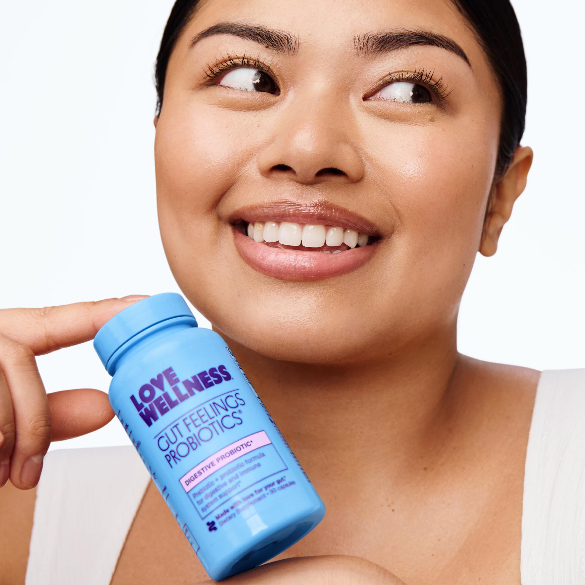 Love Wellness Gut Feelings Probiotic in hand for convenient daily gut support