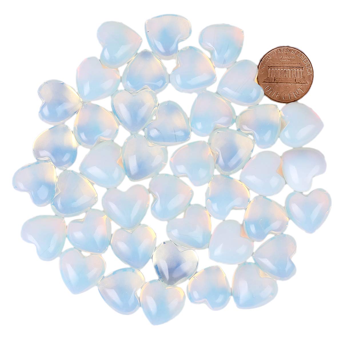 Loveliome Opalite heart palm stone in hand for calm bedside decor.