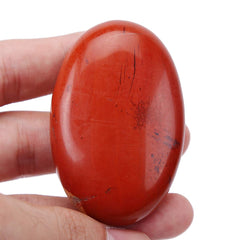 Loveliome red jasper worry stone closeup for grounding and focus.