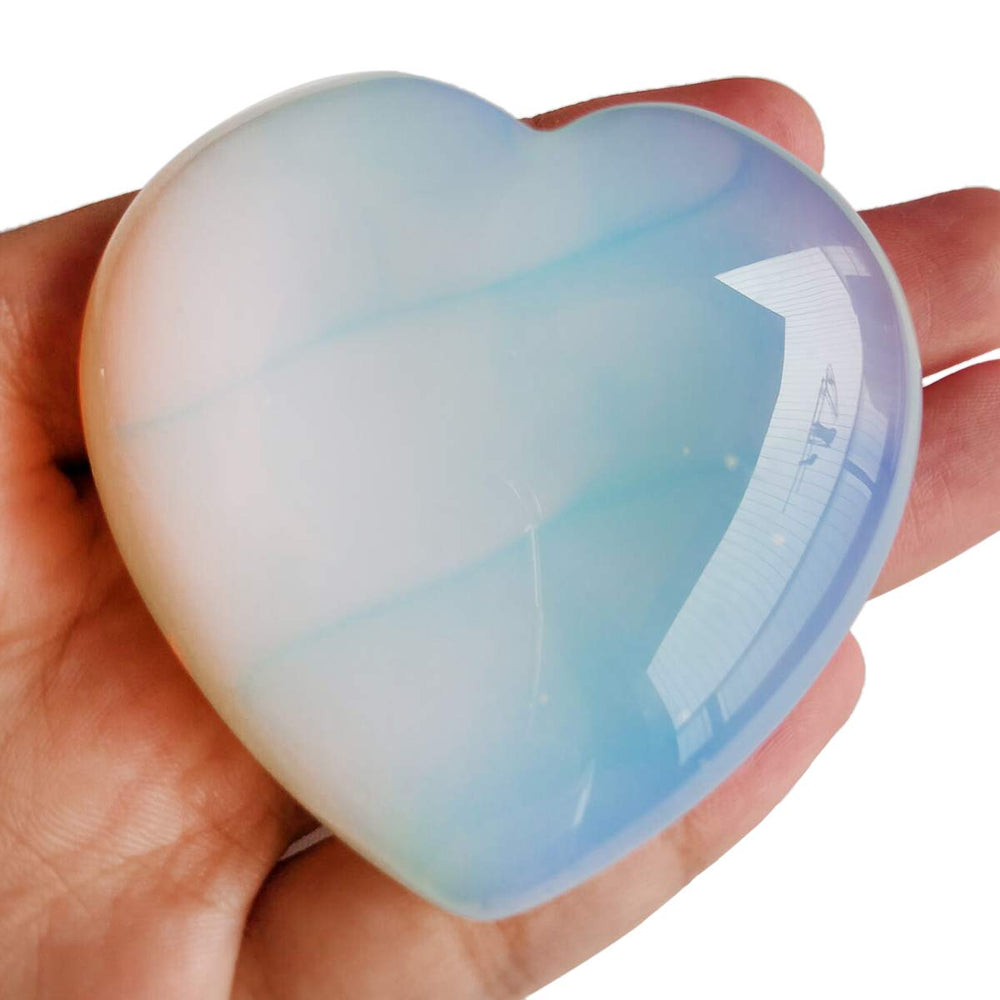 Loveliome Synthesis Opalite heart in hand, smooth touch ideal for grounding rituals.