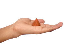 L Pedra Crystal Peach Aventurine conical pyramid on desk, adds elegant decor while centering attention.