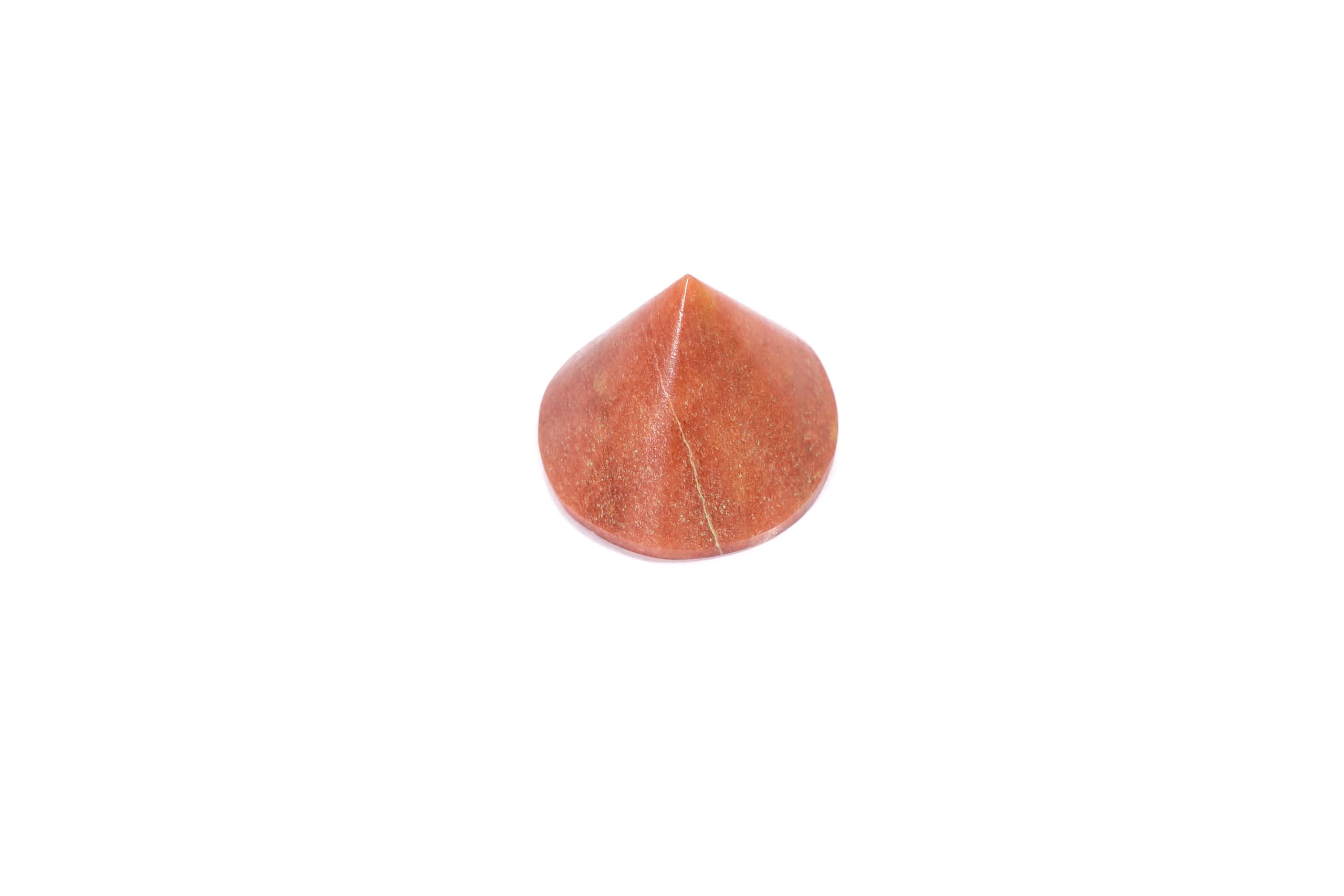 L Pedra Crystal Peach Aventurine conical pyramid on altar, promotes mindful practice and energy balance.