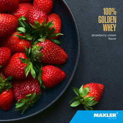 Maxler 100% Golden Whey powder being poured into a glass for a shake.