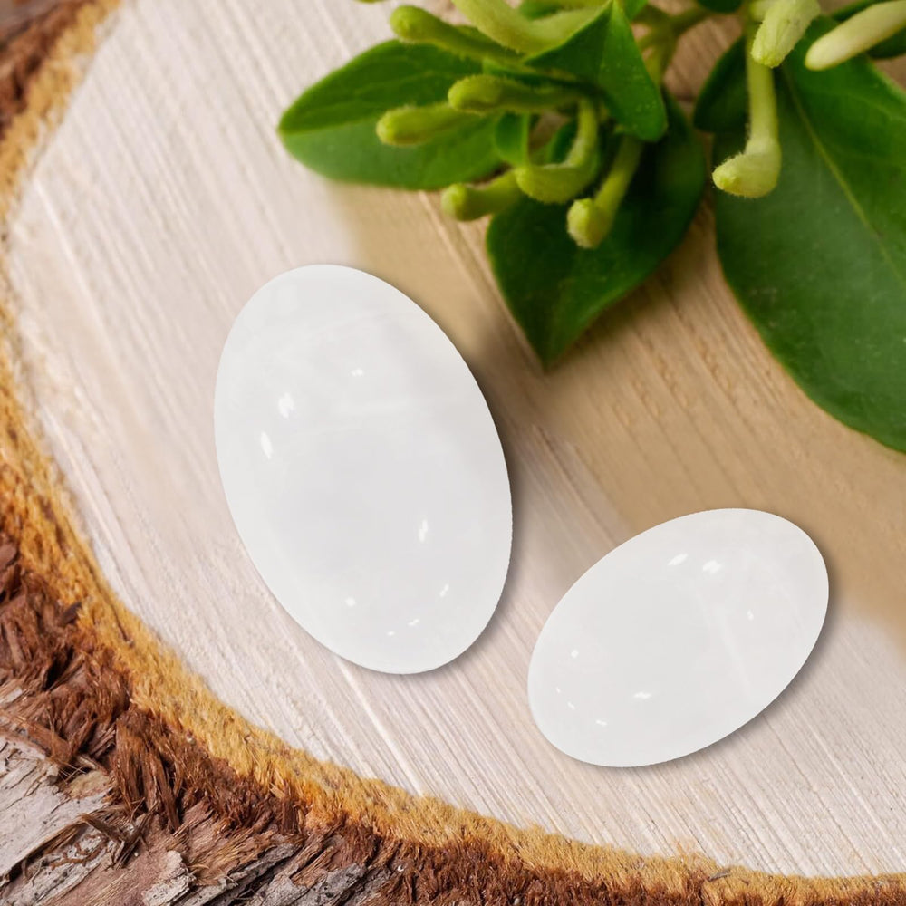MaziZhang white worry stone thumb detail highlighting smooth cool texture.