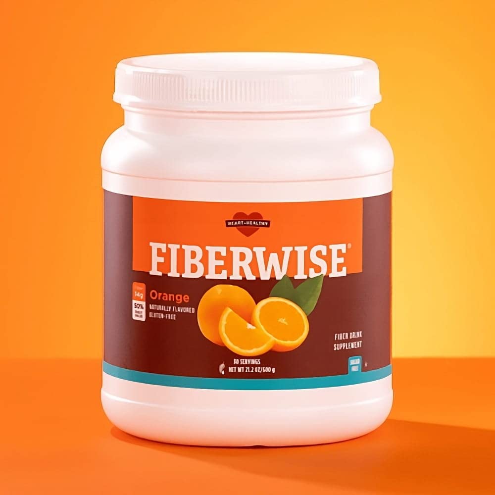 Meaneor FiberWise orange being poured into a glass for a smooth fiber drink.