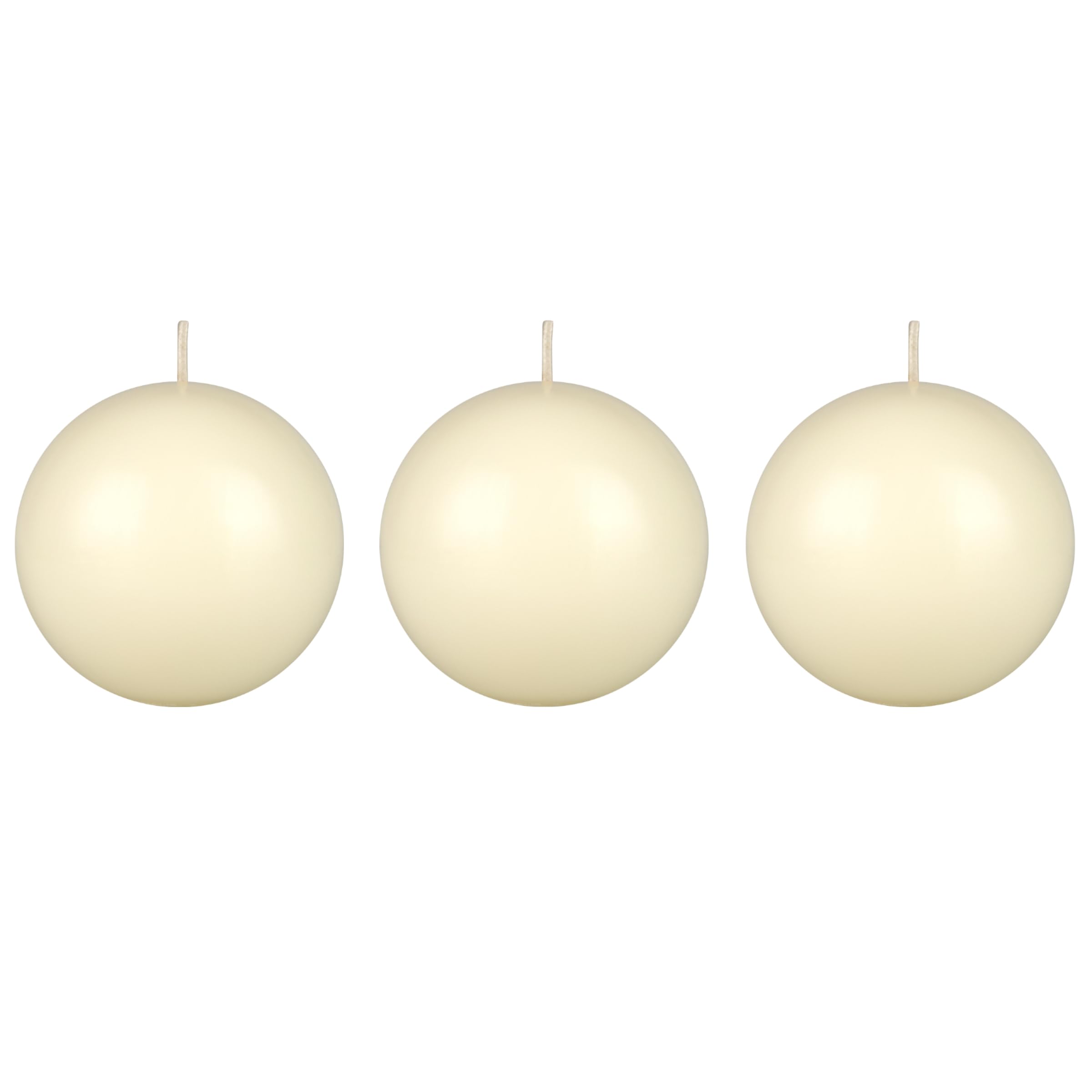 Mega Candles ivory ball candle on table creates warm ambience for dining.