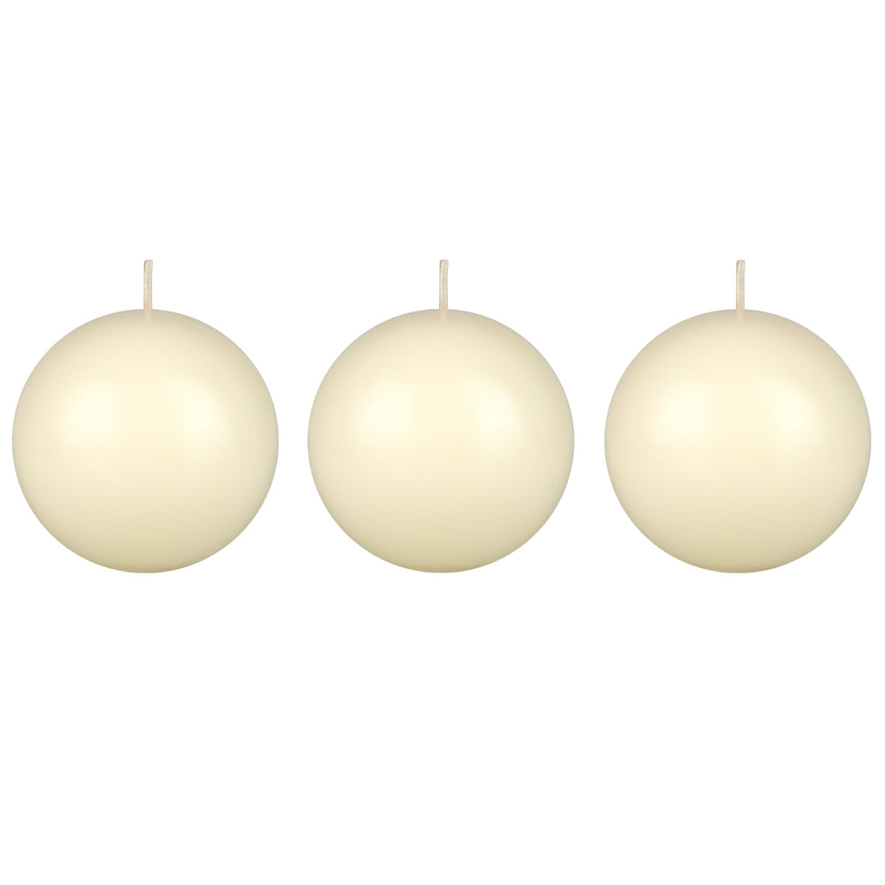 Mega Candles ivory ball candle on table creates warm ambience for dining.