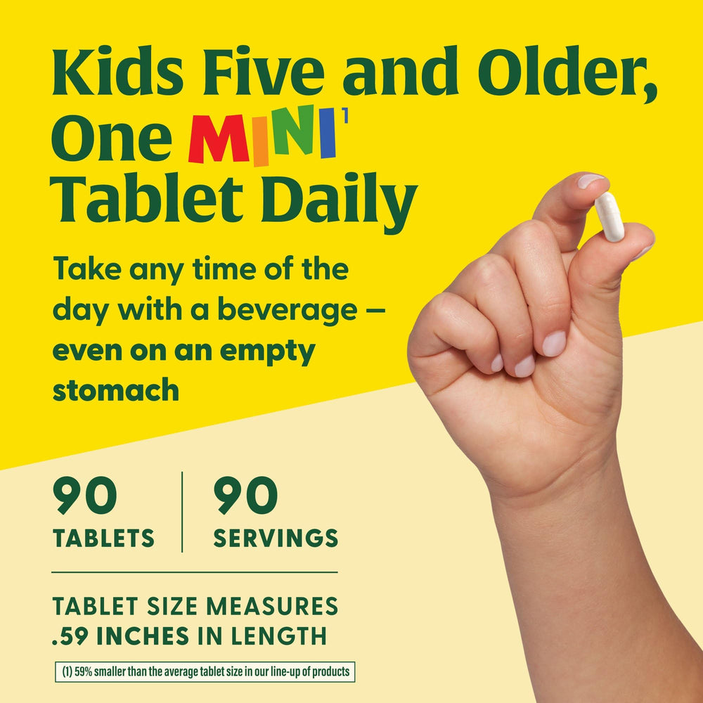 MegaFood Kids B Complex kid taking a mini tablet with a beverage