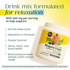Dissolving MegaFood Relax + Calm powder in water with blackberry hibiscus flavor.