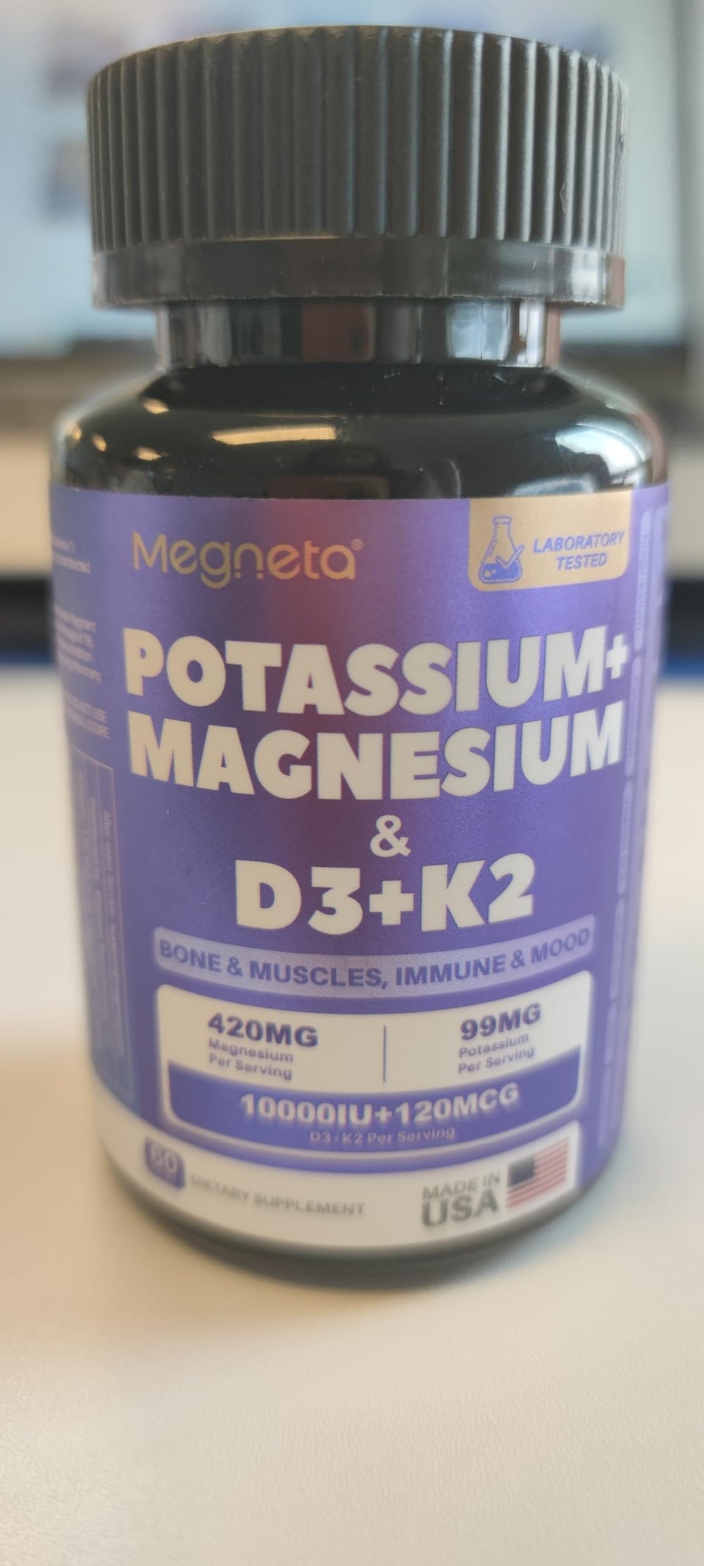 MEGNETA D3 K2 Mg molecule graphic conveys nutrient synergy.