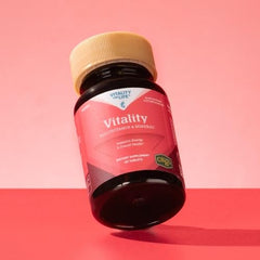 Melaleuca woman taking a multivitamin as part of daily wellness.