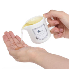Melony massage oil candle with candle-lit glow for relaxing ambiance.
