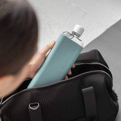 Memobottle SLIM Sea Mist sleeve in hand, emphasizing grip and insulation.