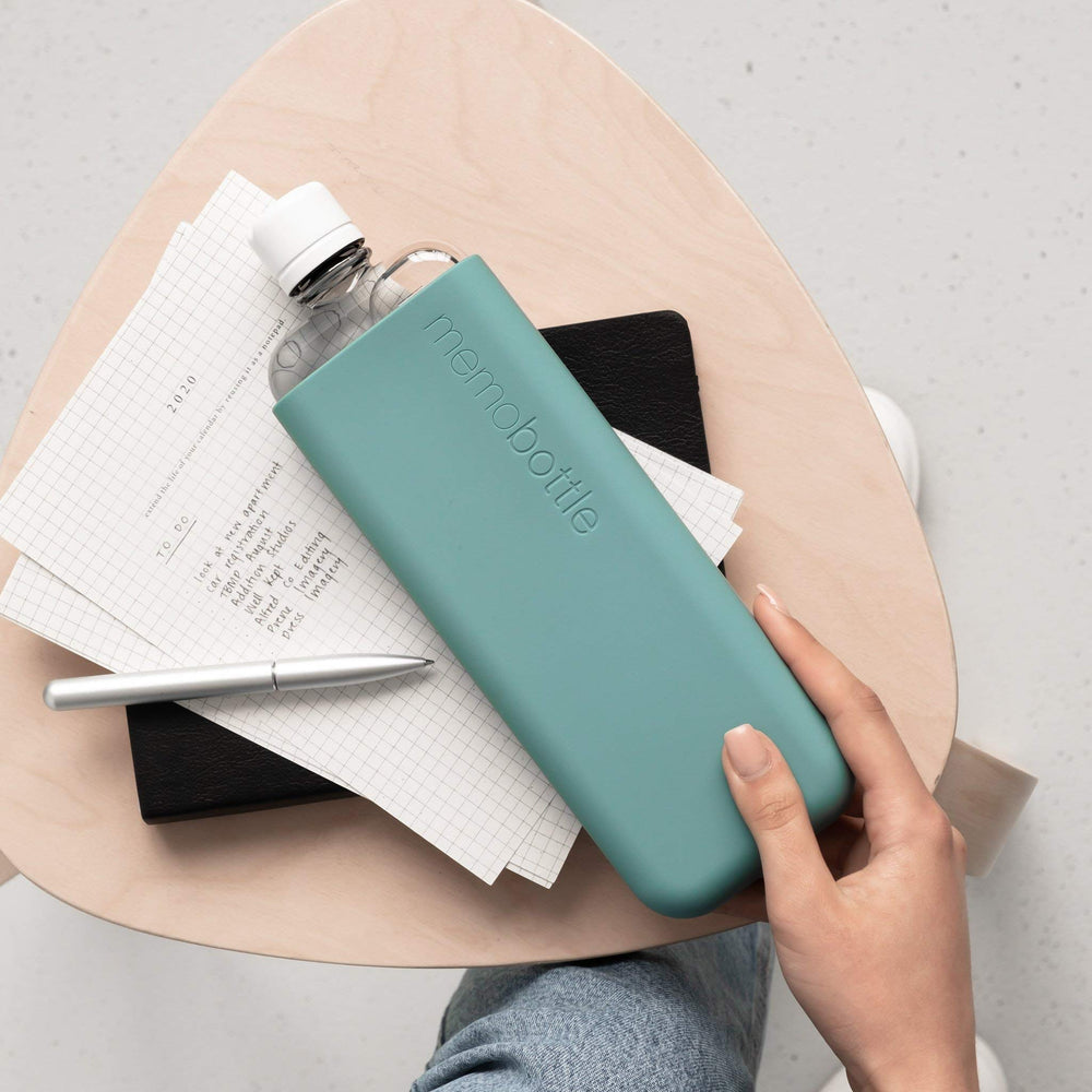 Sea Mist sleeve with bottle in transit, showcasing drop protection concept.