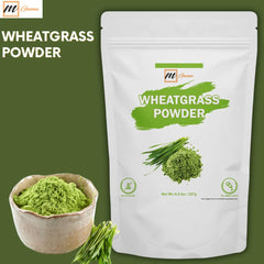 mganna Pure Wheatgrass Powder scoop in use offers an easy nutrient boost for smoothies.