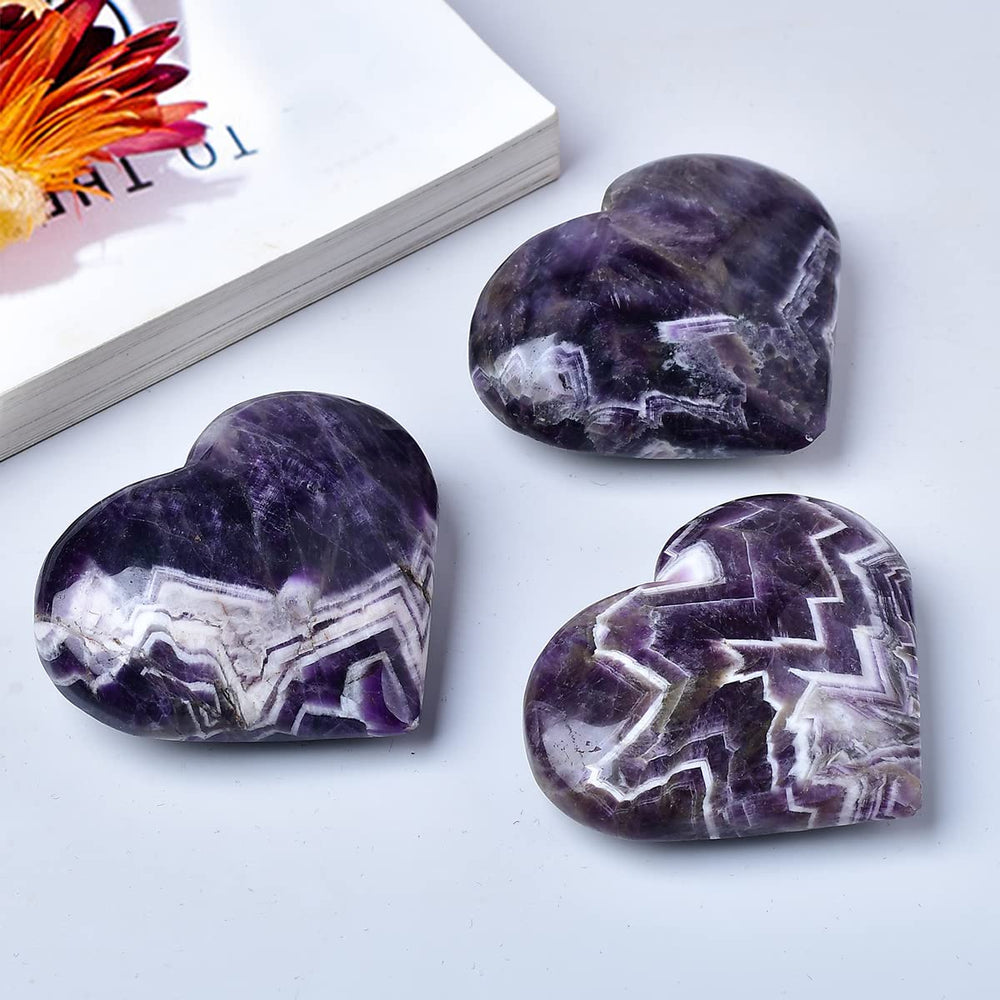 MOGEMT Dream Amethyst heart palm stone studio shot; natural texture and glow.