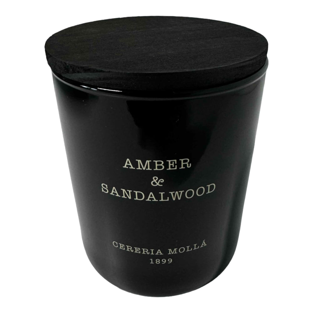 Molla 1899 handmade candle jar with amber and sandalwood scent for elegant ambiance.