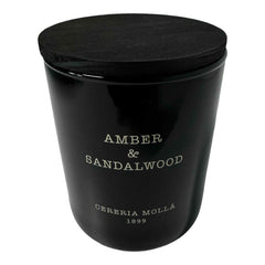 Molla 1899 handmade candle jar with amber and sandalwood scent for elegant ambiance.
