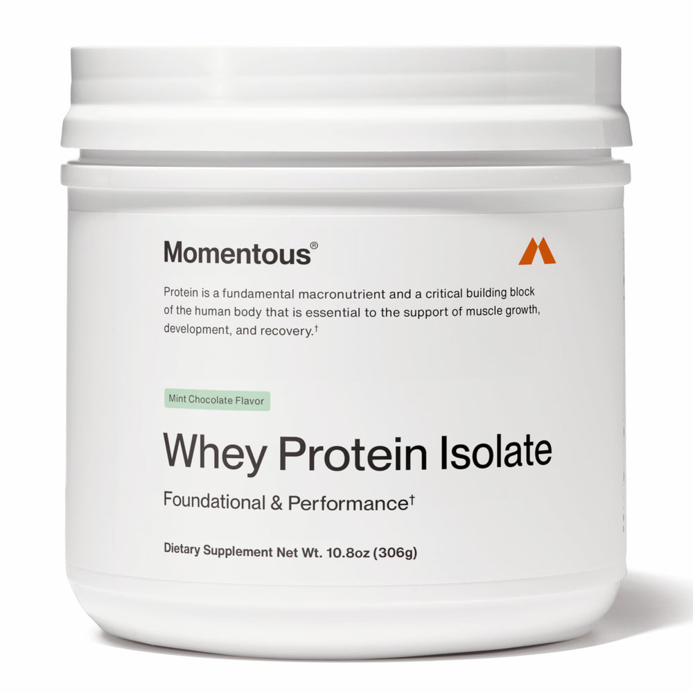 Momentous Essential grass-fed whey bottle pouring, smooth protein for post-workout recovery.