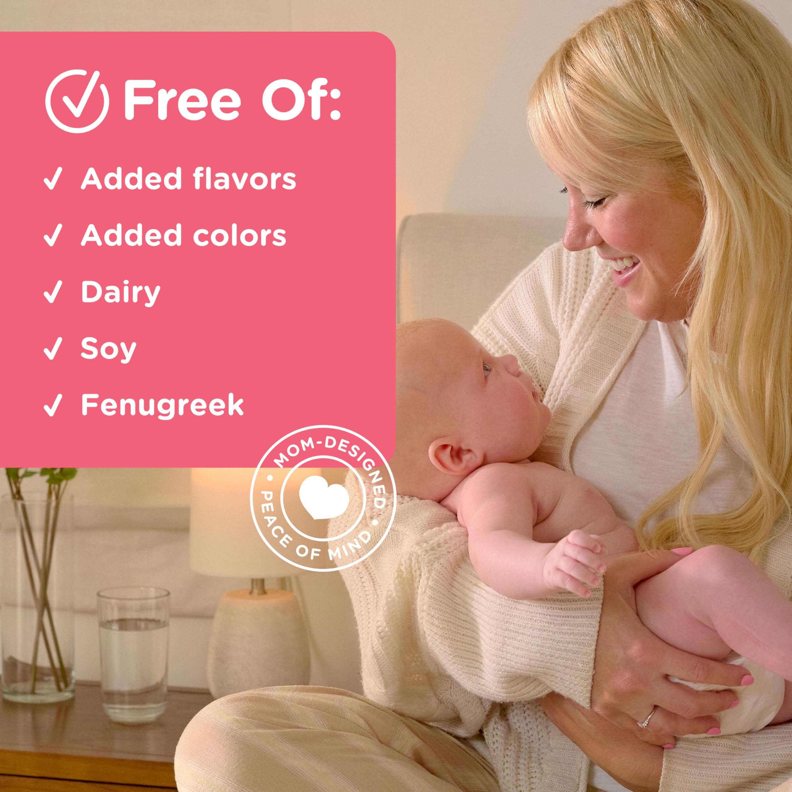 Mother nursing baby with Mommy's Bliss bottle nearby.