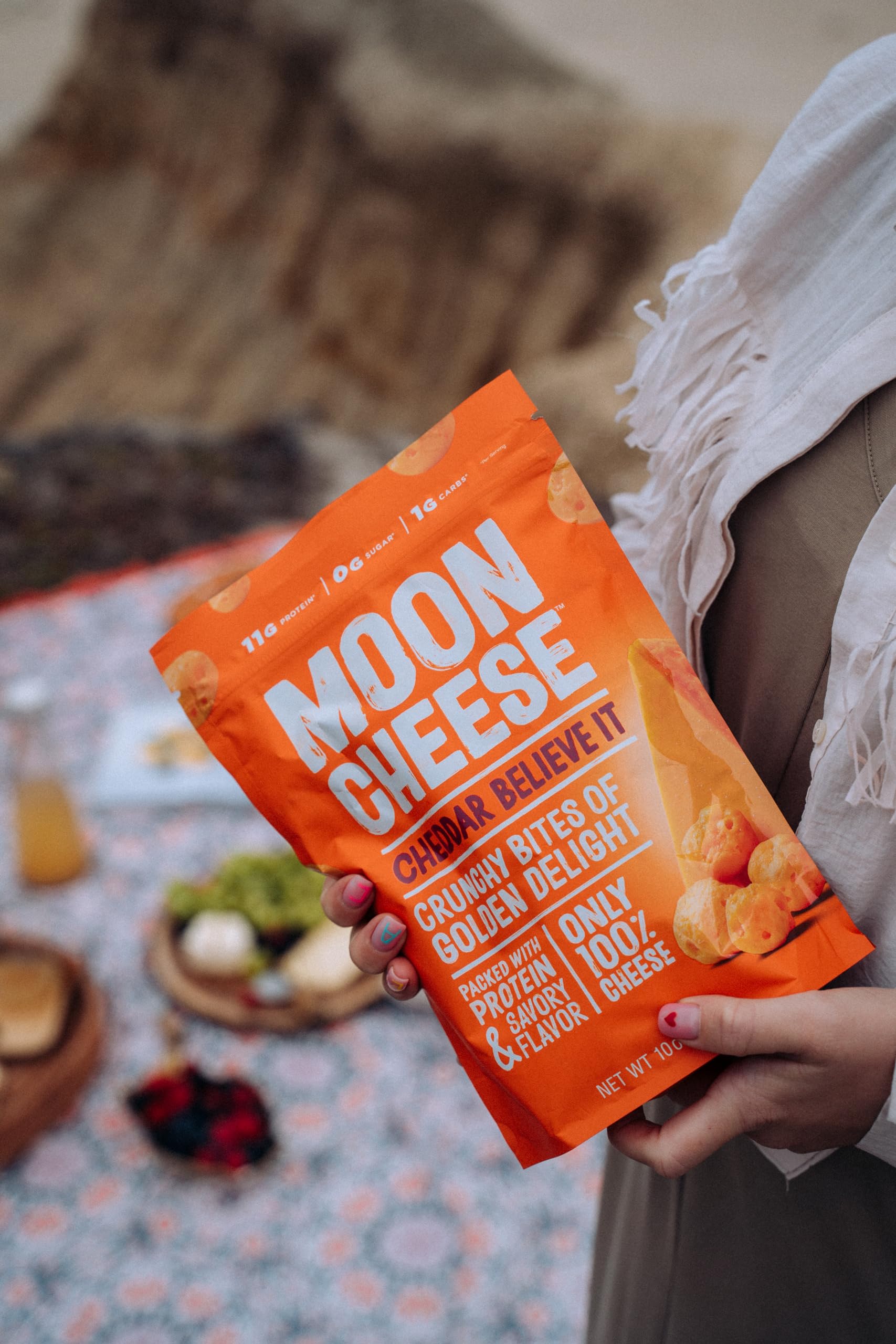 Moon Cheese Cheddar Believe It three-pack viewed from a side angle