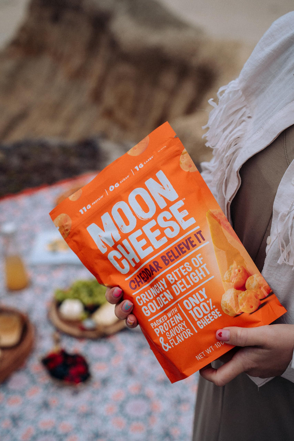 Moon Cheese Cheddar Believe It three-pack viewed from a side angle